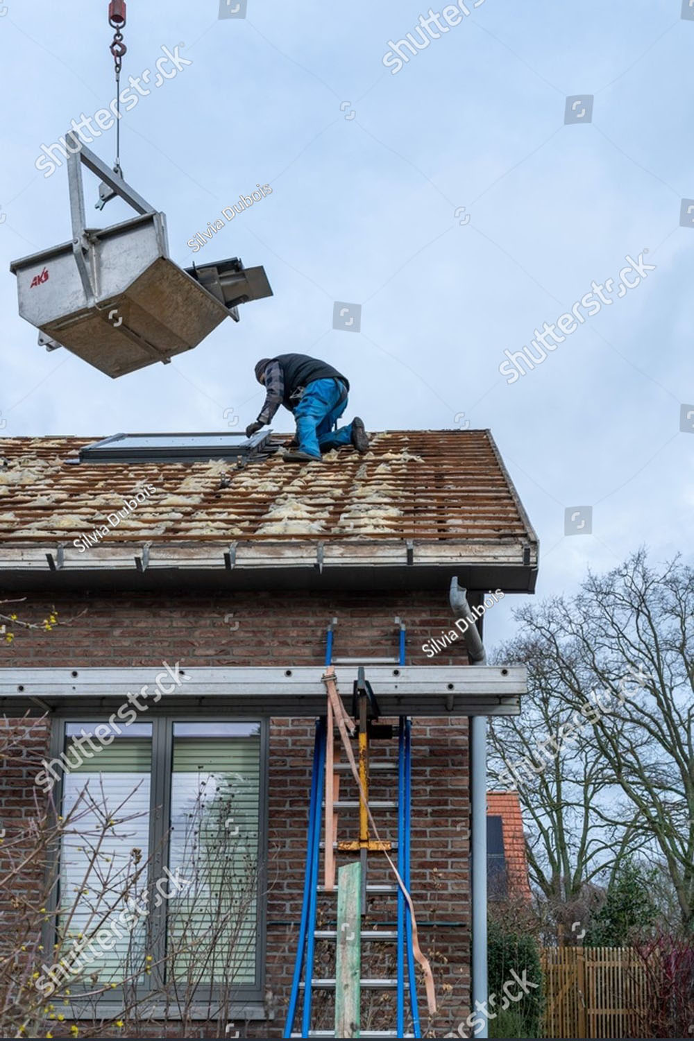 shutterstock-photo-roof-renovation-works-on-a-residential-house-in-beringen-belgium-february-worker-2755436979